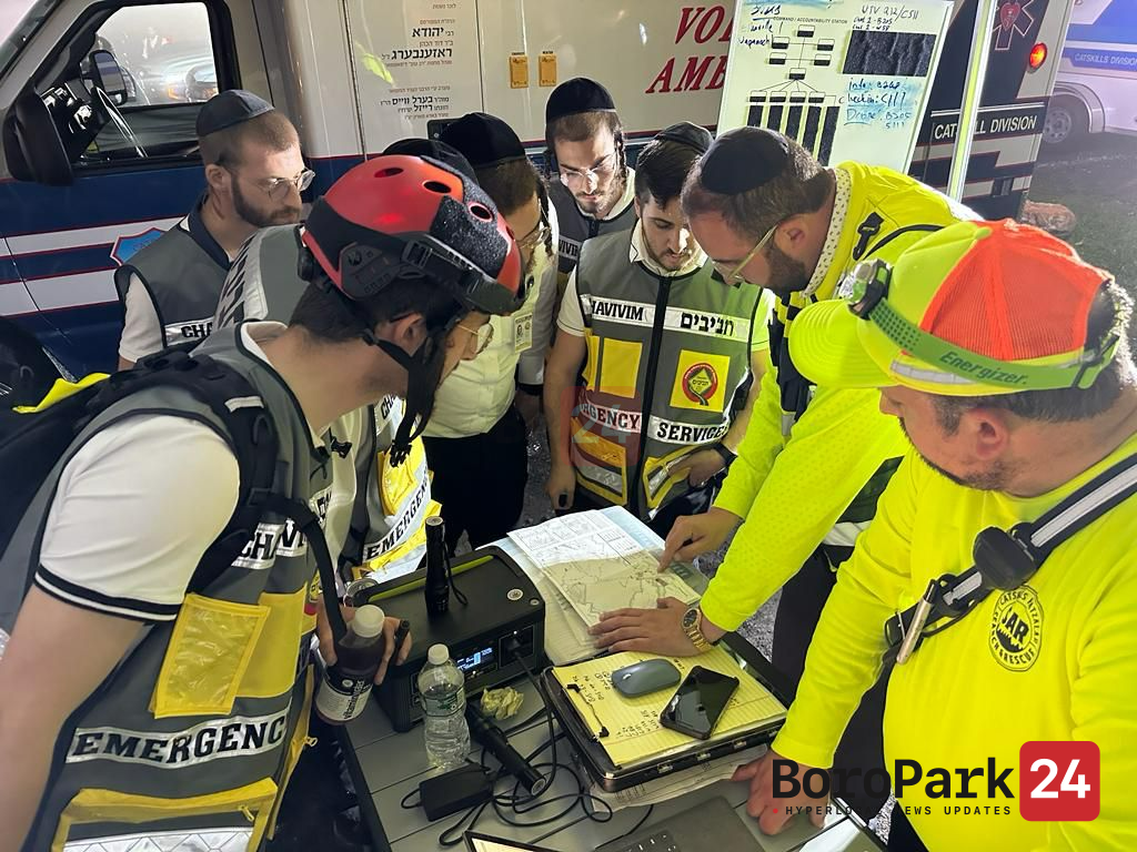 Chavivim and SAR members at the Catskills command tabletop reviewing the search-area map during the overnight operation