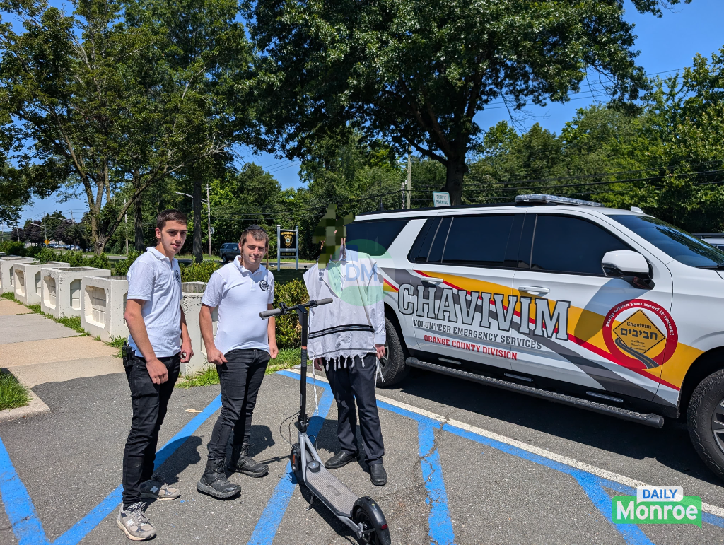 Monroe Chavivim returning the recovered scooter to its owner at Ramapo Police